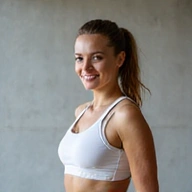 Smiling client D, a young professional woman, confidently working out